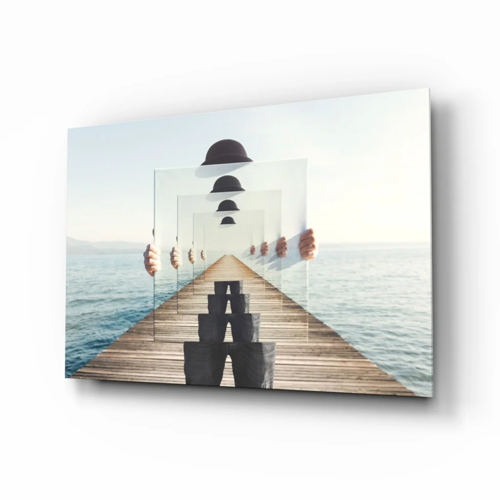 Stunning glass wall art of wooden pier with floating black cubes and ocean reflections