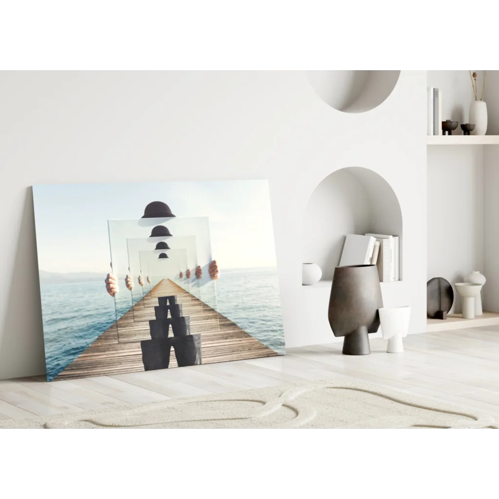 Modern glass wall art of mirrored figure on ocean pier in black and white