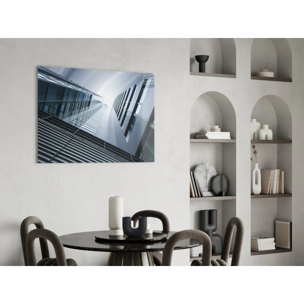 Modern black round table with minimalist design, white vase, and glass wall art