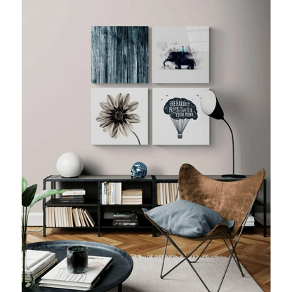 Stunning glass wall art with black butterfly chair, gold cushion, blue pillow