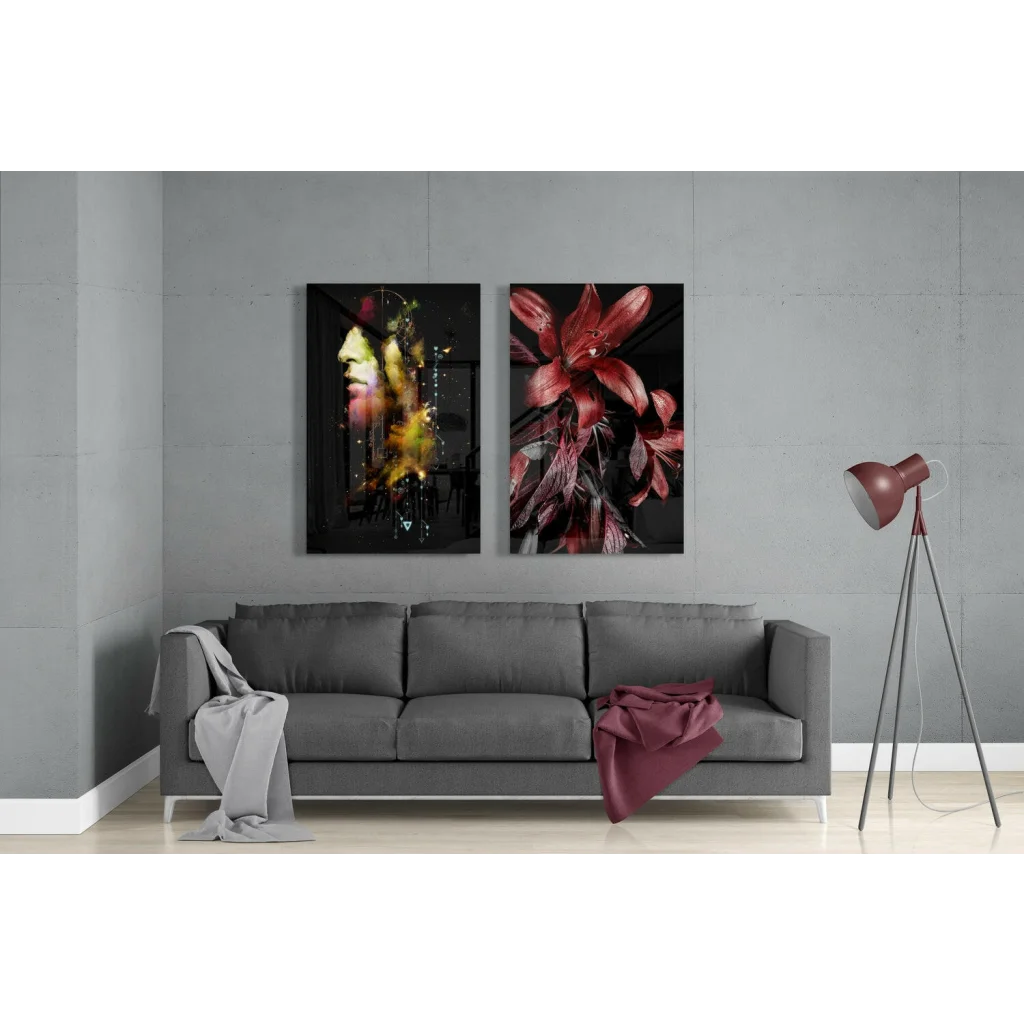 Gray upholstered sofa with gray throw and maroon item near glass wall art
