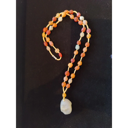Stunning Gobi Desert agate bead necklace in warm orange, red, and amber tones with white jade pendant