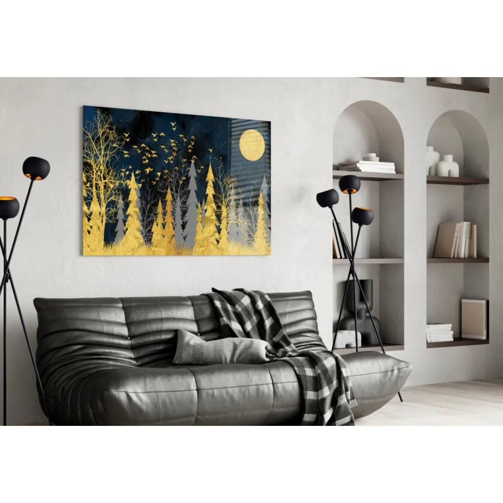 Stunning gold foil forest moon glass wall art on black leather couch with plaid throw