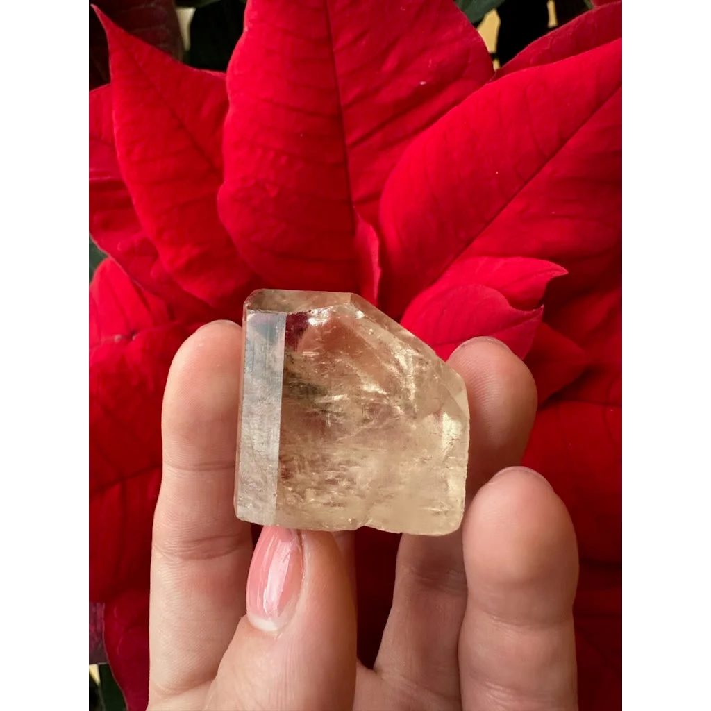 Hand holding translucent golden topaz from Shigar Valley, Pakistan