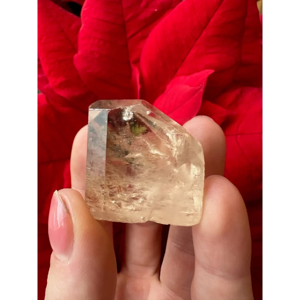 Hand holding translucent golden topaz from Shigar Valley, Pakistan