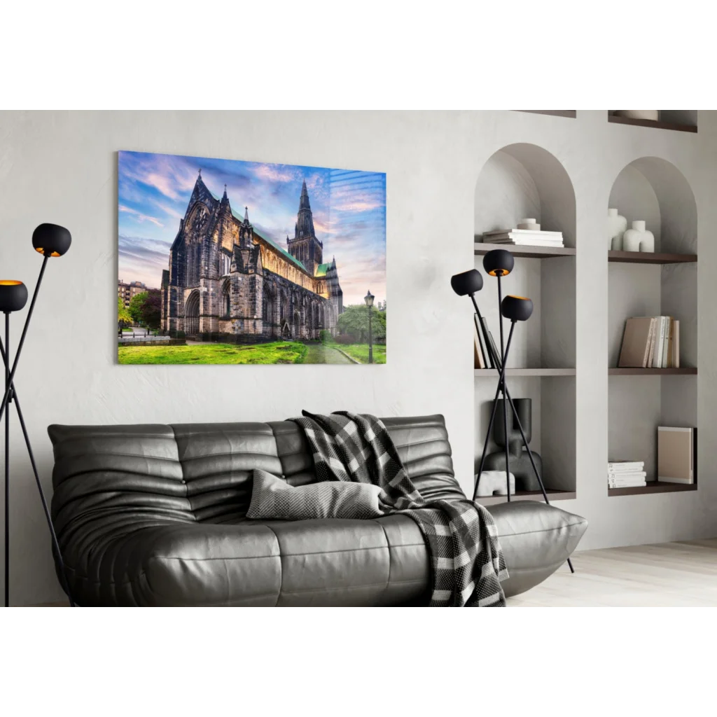 Black leather sofa with plaid blanket near Gothic cathedral wall art