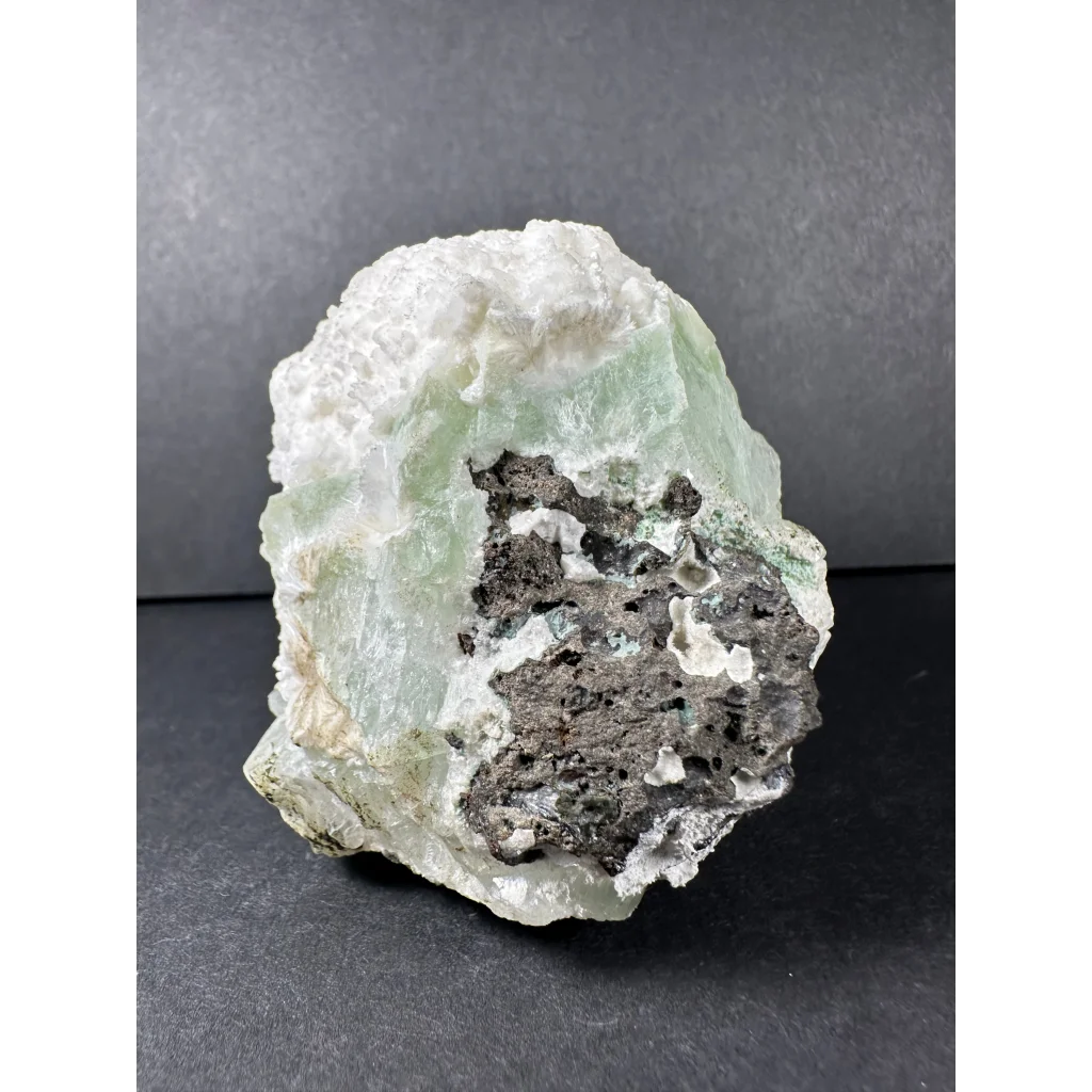 Stunning green apophyllite crystal cluster from India with pale green mineral, white matrix, and dark gray inclusions