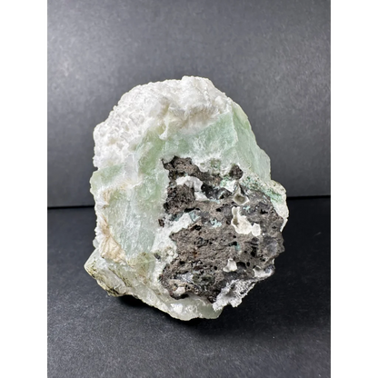 Stunning green apophyllite crystal cluster from India with pale green mineral, white matrix, and dark gray inclusions