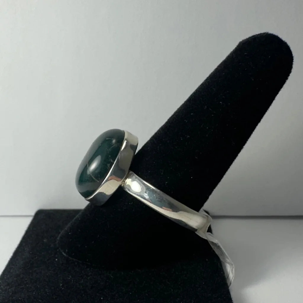 Sleek sterling silver serpentine ring with oval green gemstone