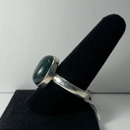 Sleek sterling silver serpentine ring with oval green gemstone