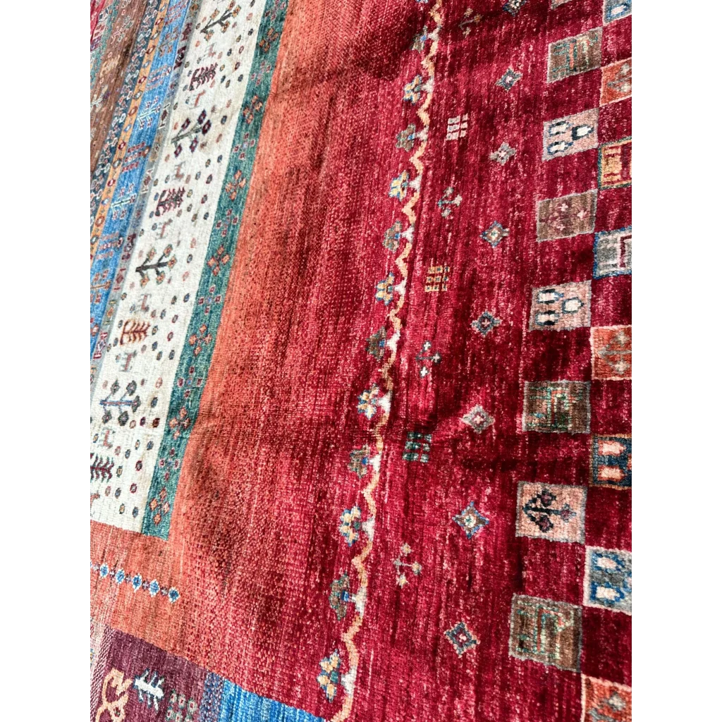 Stunning hand-knotted Afghan Ghazni wool tribal rug in rich burgundy with teal, cream, and blue patterns