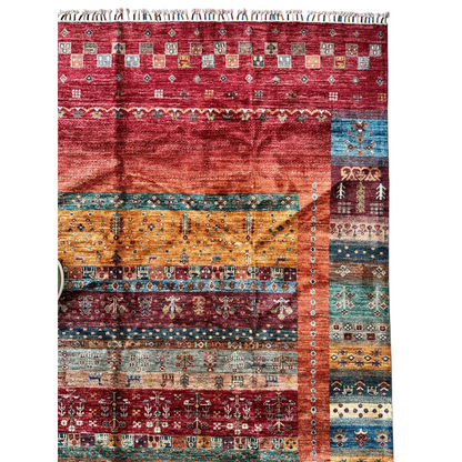 Vibrant hand-knotted Afghan Ghazni wool tribal rug with geometric patterns