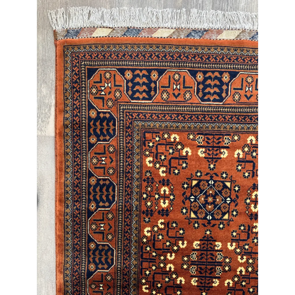 Stunning Afghani Bukharayi rug in orange navy with geometric patterns