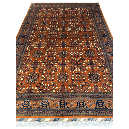 Handwoven Afghani Bukharayi rug in orange and navy with bold geometric patterns