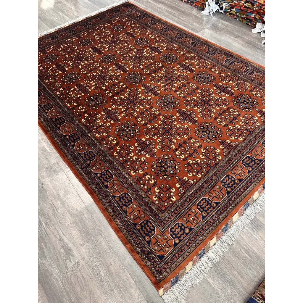 Stunning Afghani Bukharayi rug in rust-orange with bold geometric patterns