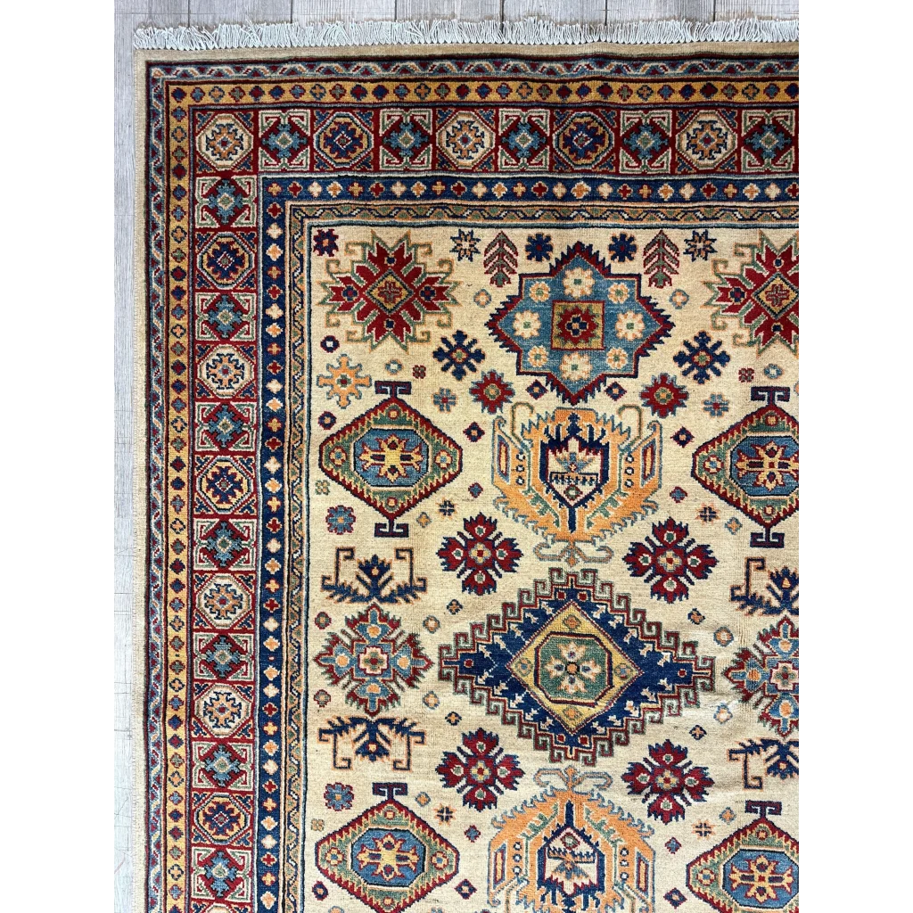 Afghan Kazak hand-knotted rug in beige with intricate geometric patterns and fringes