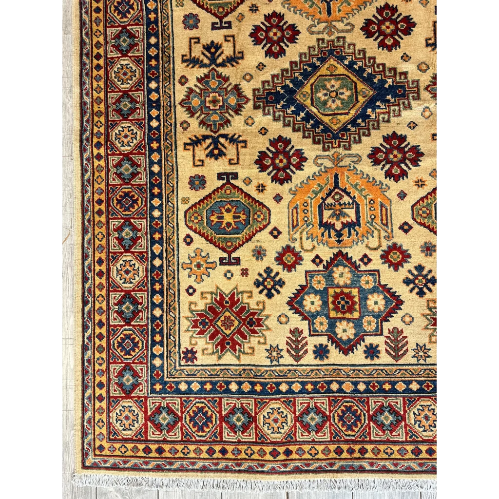 Stunning hand-knotted beige Kazak rug from Afghanistan with intricate geometric and floral patterns in deep red, navy blue, and gold accents