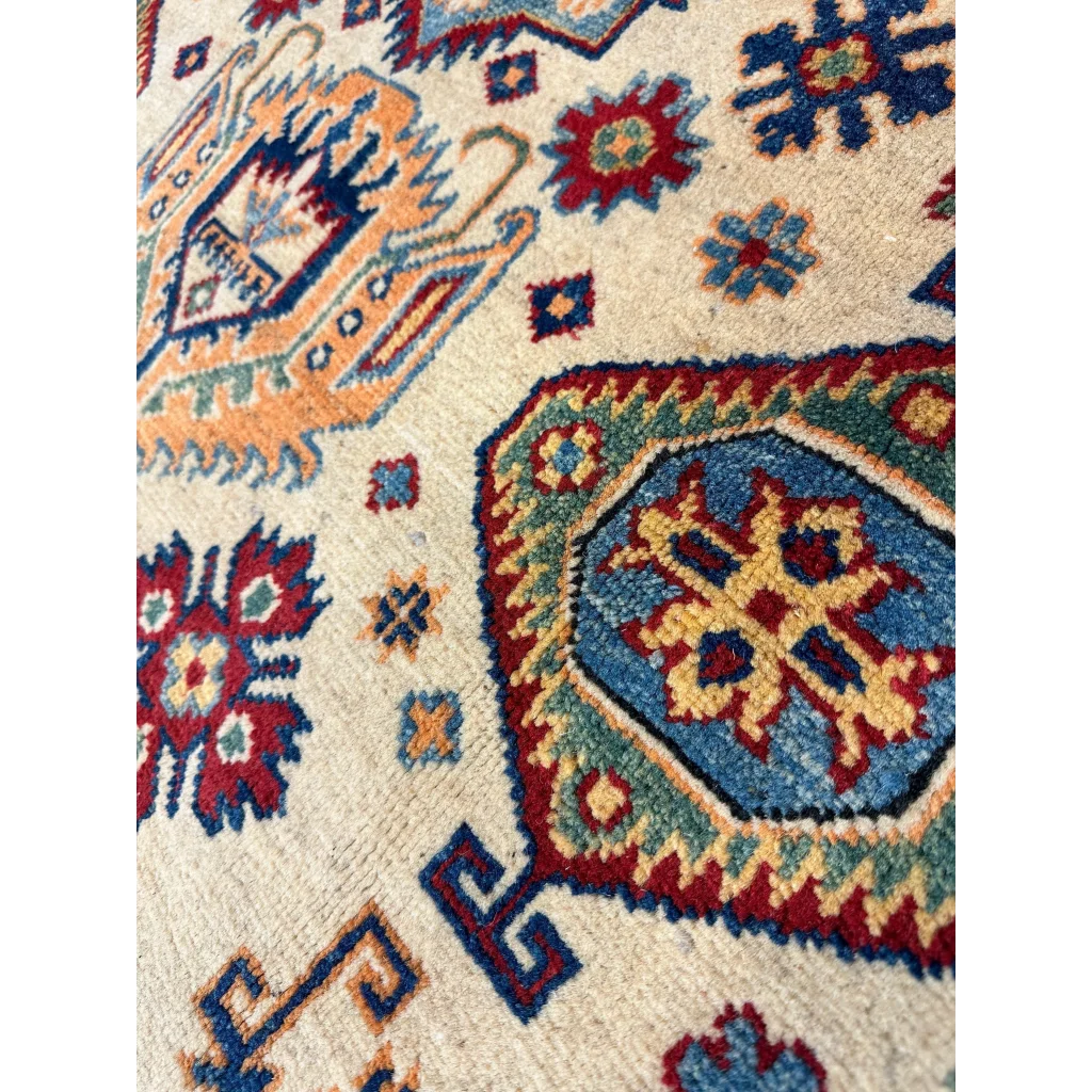 Afghan Kazak hand-knotted rug in beige with intricate red, blue, orange and green patterns