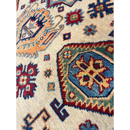 Afghan Kazak hand-knotted rug in beige with intricate red, blue, orange and green patterns