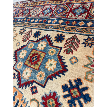 Afghan Kazak hand-knotted rug in beige with blue, red and green geometric patterns