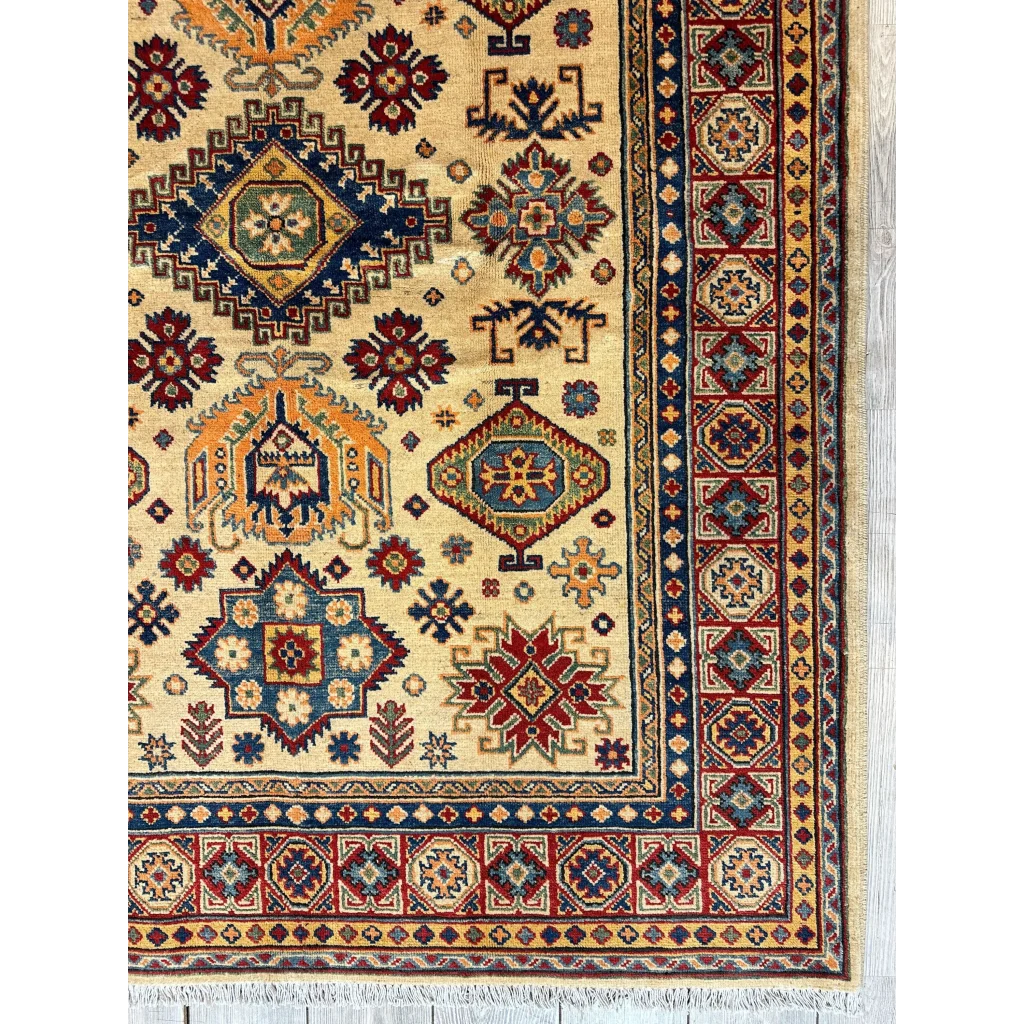 Stunning beige Kazak rug from Afghanistan with intricate red, navy, gold patterns