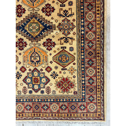 Stunning beige Kazak rug from Afghanistan with intricate red, navy, gold patterns