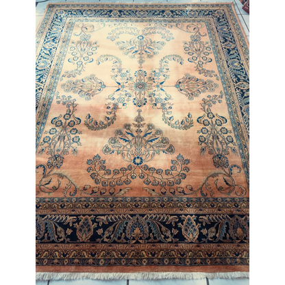 Stunning hand-knotted wool rug with navy border and peach florals