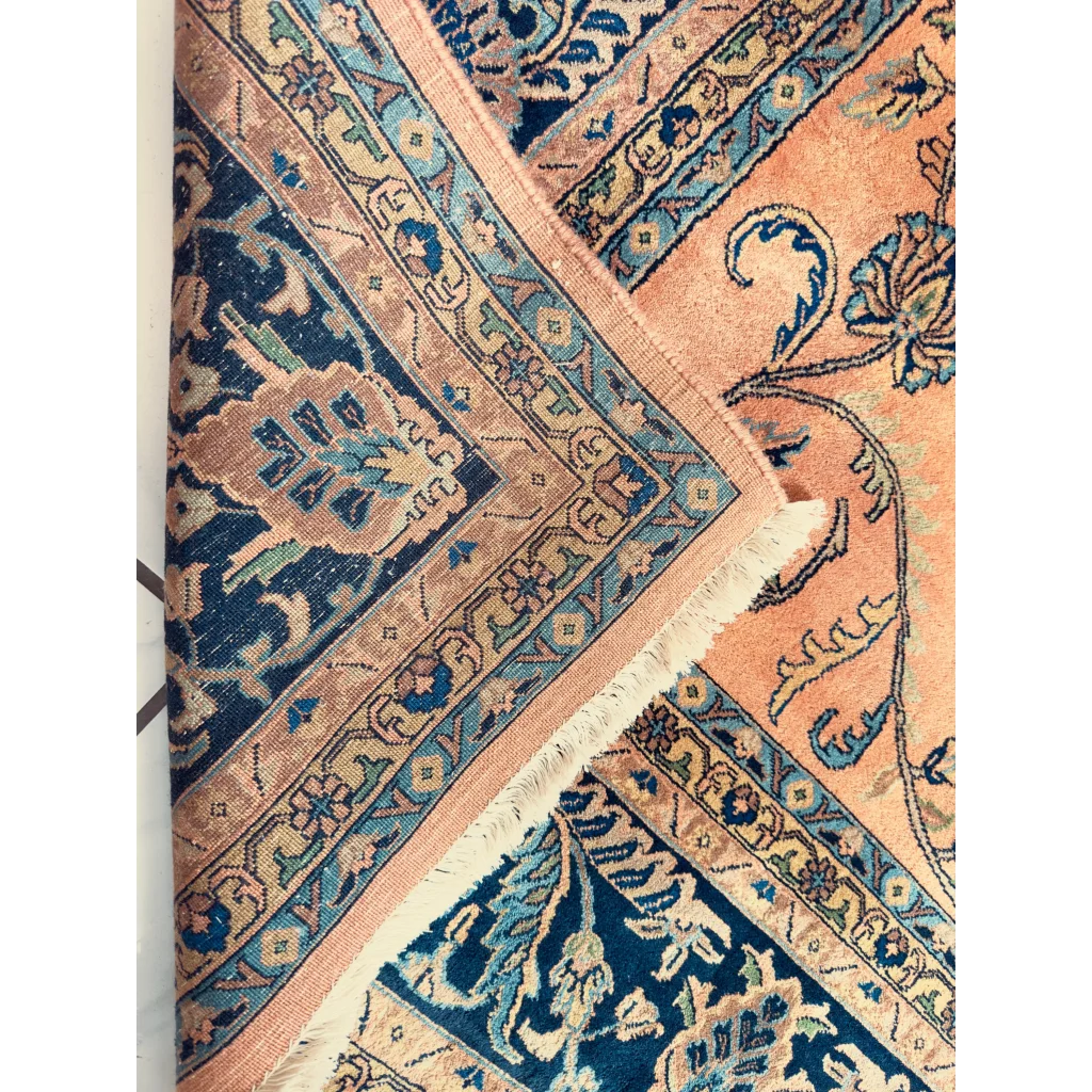Stunning hand-knotted wool rug with navy border and peach florals