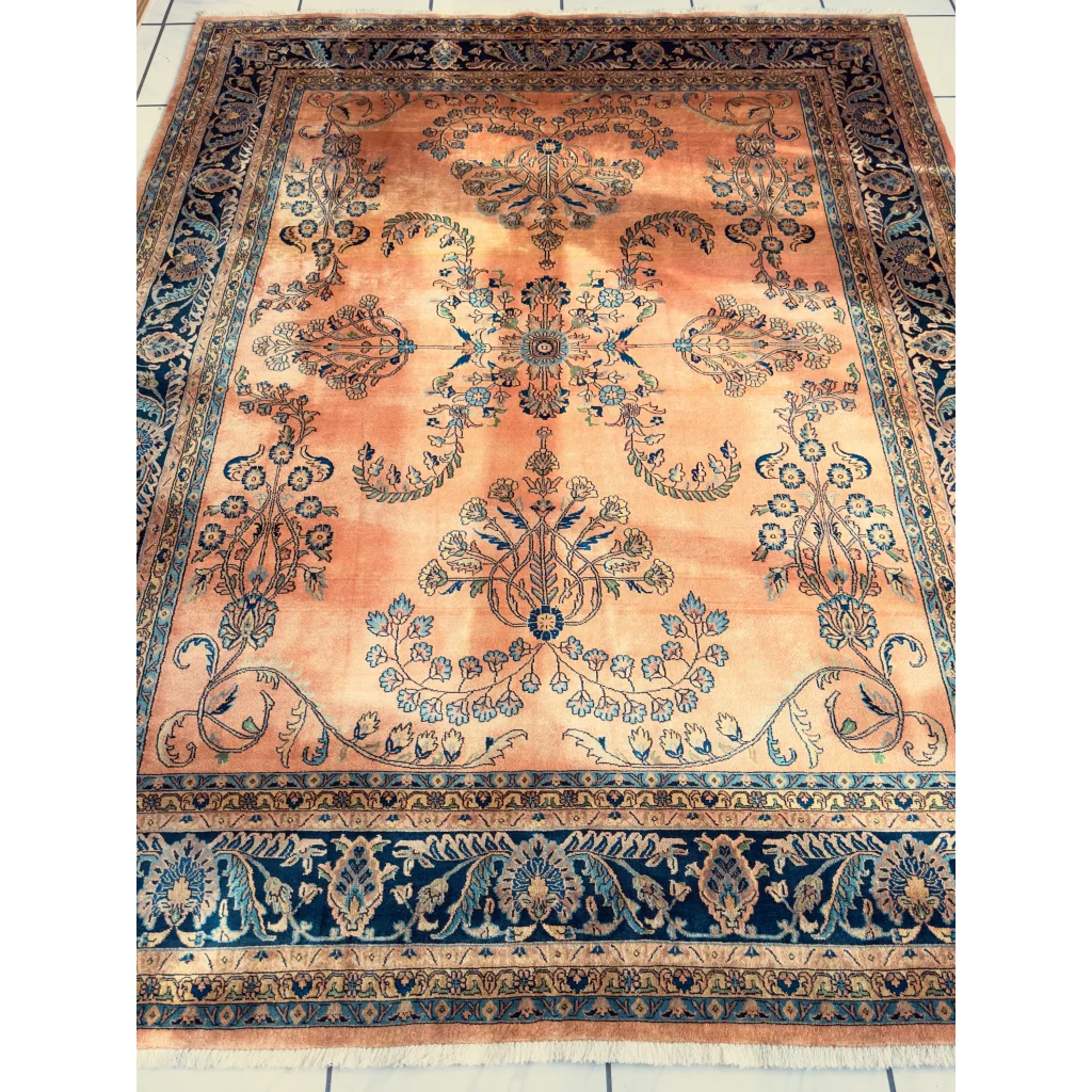 Stunning hand-knotted wool rug with navy border and peach florals
