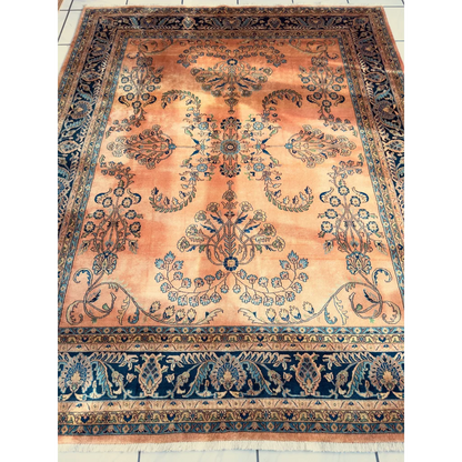 Stunning hand-knotted wool rug with navy border and peach florals