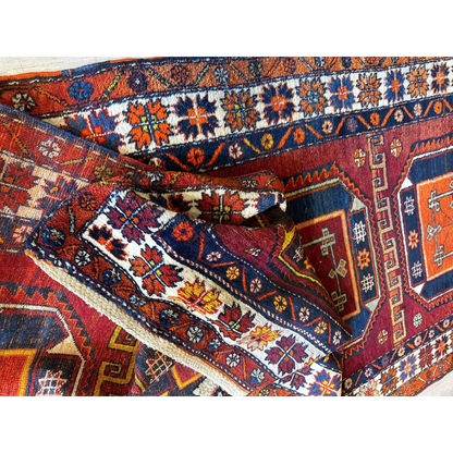 Vibrant Kurdish Kazak wool pile geometric motifs runner with floral patterns