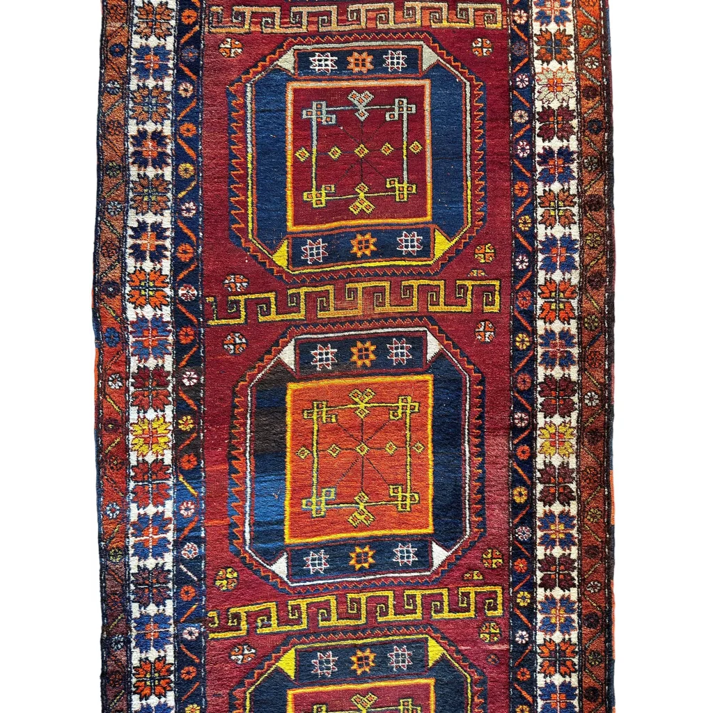 Vintage Kurdish Kazak geometric runner 1940s, close-up of bold red and blue field pattern