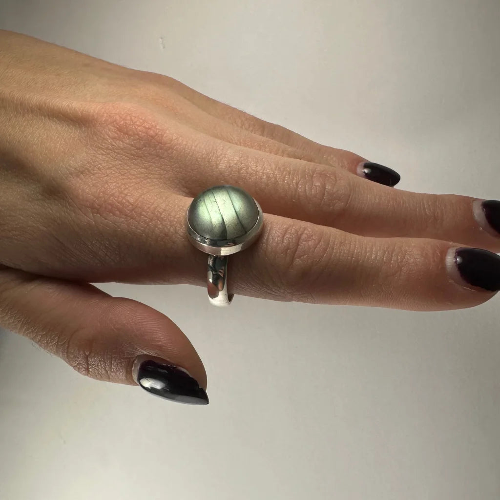Sleek silver labradorite ring with iridescent blue green flash
