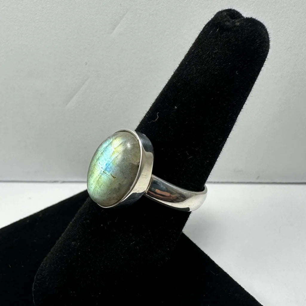 Sleek silver labradorite ring with oval stone and iridescent blue green flashes