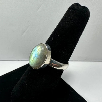 Sleek silver labradorite ring with oval stone and iridescent blue green flashes