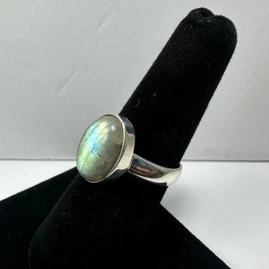Sleek silver labradorite ring with oval stone and iridescent blue green flashes