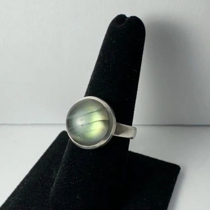 Sleek silver labradorite ring with iridescent blue green cabochon flash