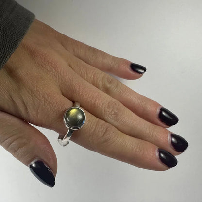 Stunning labradorite ring with shimmering green gold glow in silver bezel