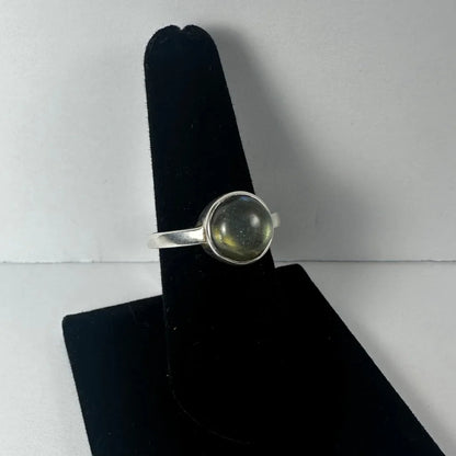 Stunning labradorite ring with shimmering green gold glow in silver bezel