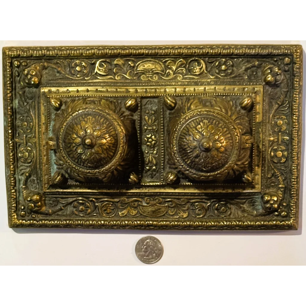Ornate brass double inkwell desk accessory from late 19th century with floral designs