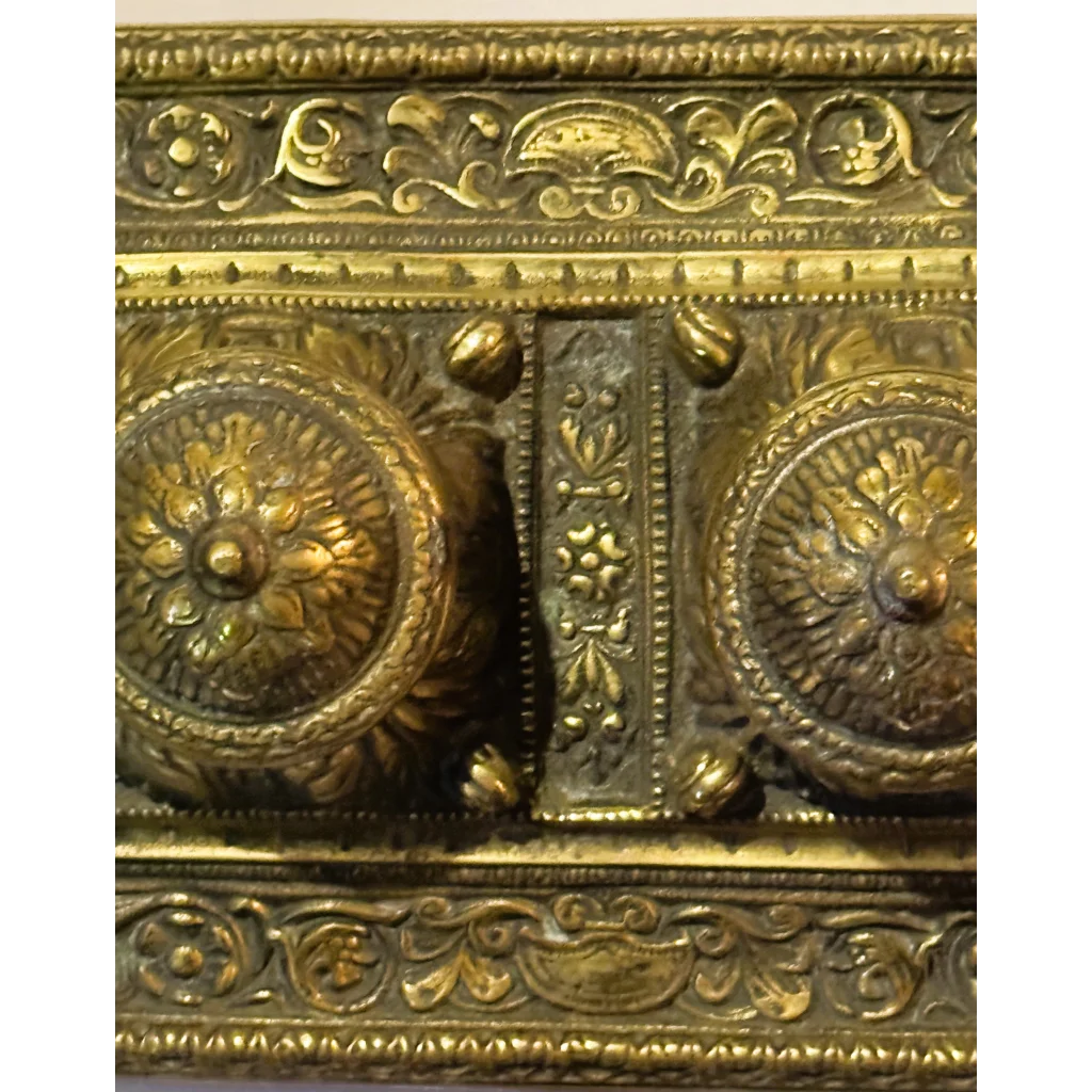 Ornate gold-toned metalwork on Late 19th Century Brass Double Inkwell Desk Accessory