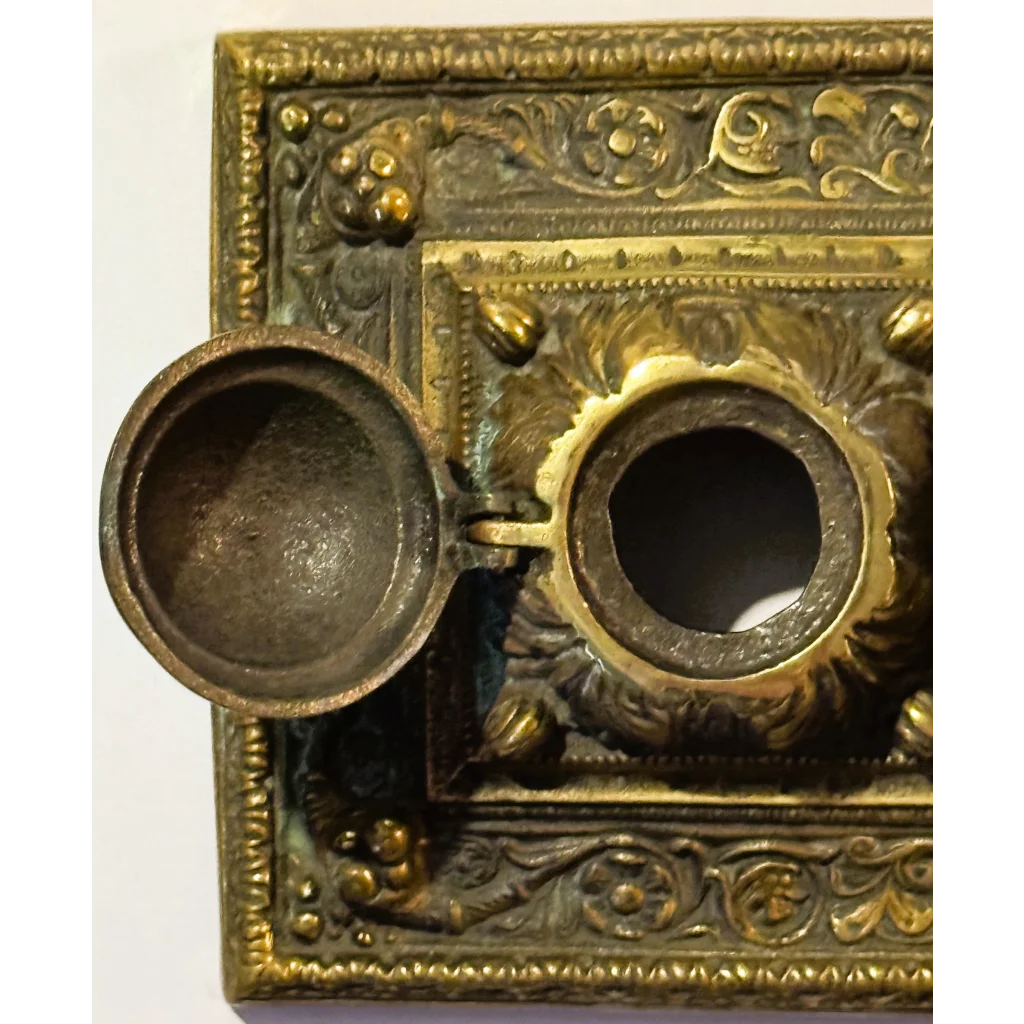 Ornate brass double inkwell with hinged lid from late 19th century desk accessories