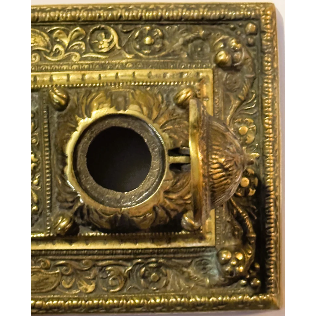 Ornate brass mail slot on late 19th century brass double inkwell desk accessory