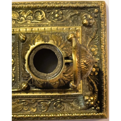 Ornate brass mail slot on late 19th century brass double inkwell desk accessory