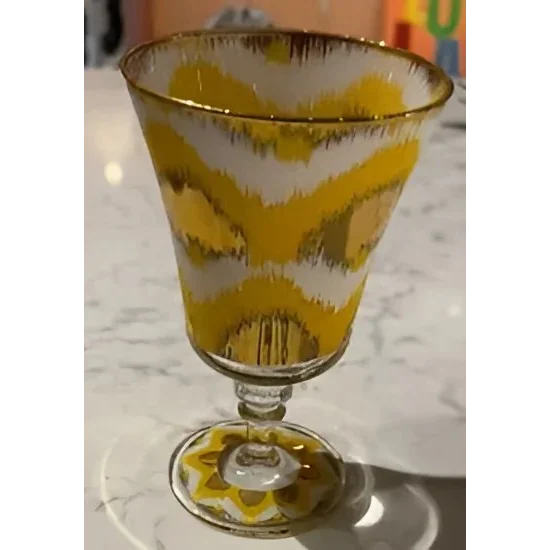 Vibrant Les Ottomans Ikat gold wine glass with zigzag pattern and gold rim