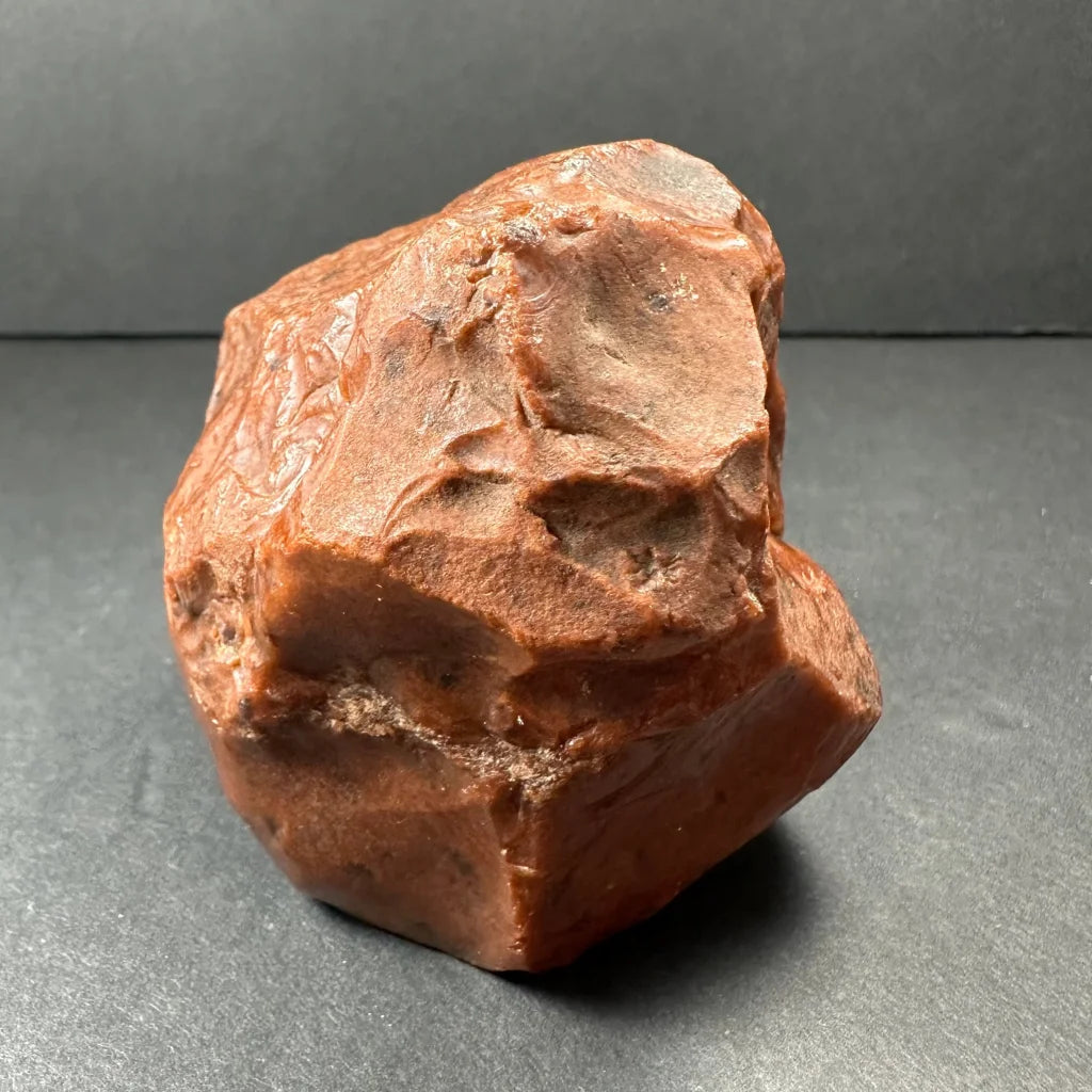 Stunning mahogany obsidian natural stone specimen with rough reddish-brown irregular shape and mineral veins