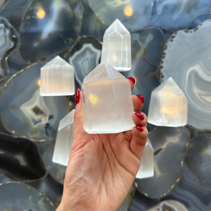 Hand holding stunning Moroccan selenite obelisk crystal tower 210g