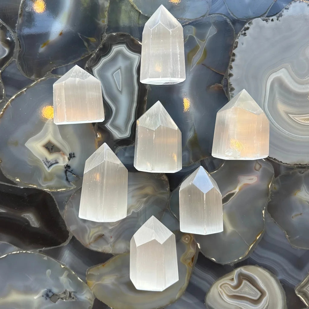 Stunning Moroccan selenite obelisk tower with quartz points on agate slices