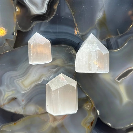 Three 3-6cm Moroccan selenite obelisk towers on agate