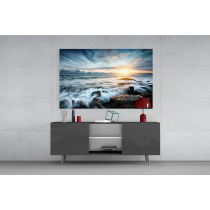 Vibrant ocean sunset glass wall art with crashing waves on rocks